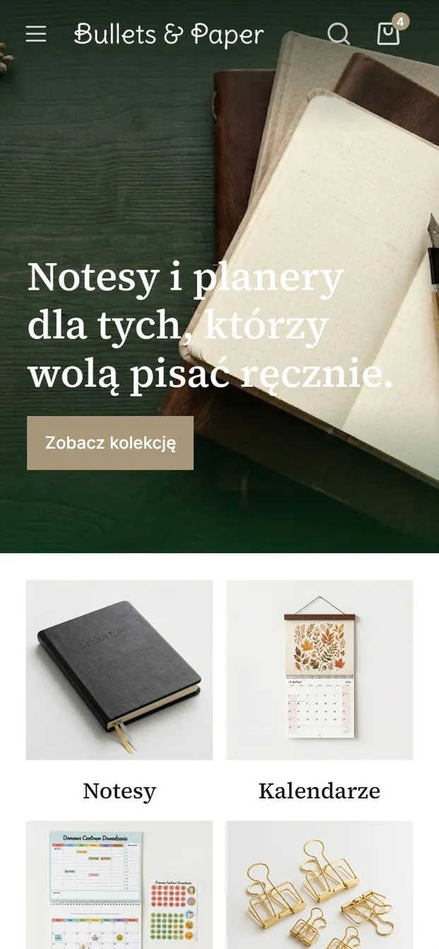 Sklep Bullets & Paper na telefonie - ciemnozielony baner ze zdjeciem otwartego notesu i haslem „Notesy i planery dla tych, którzy wolą pisać ręcznie”.